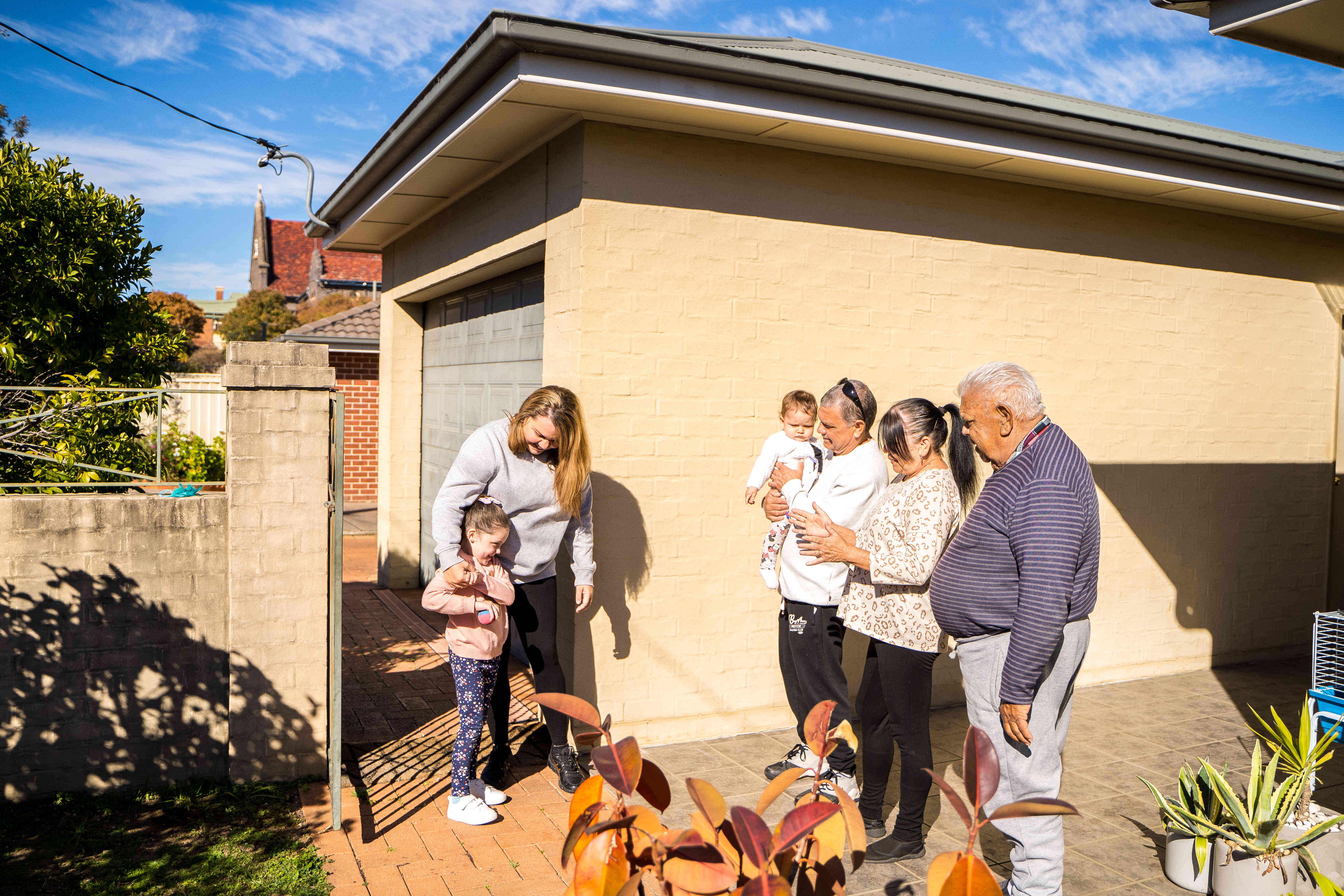 Family standing outside their home