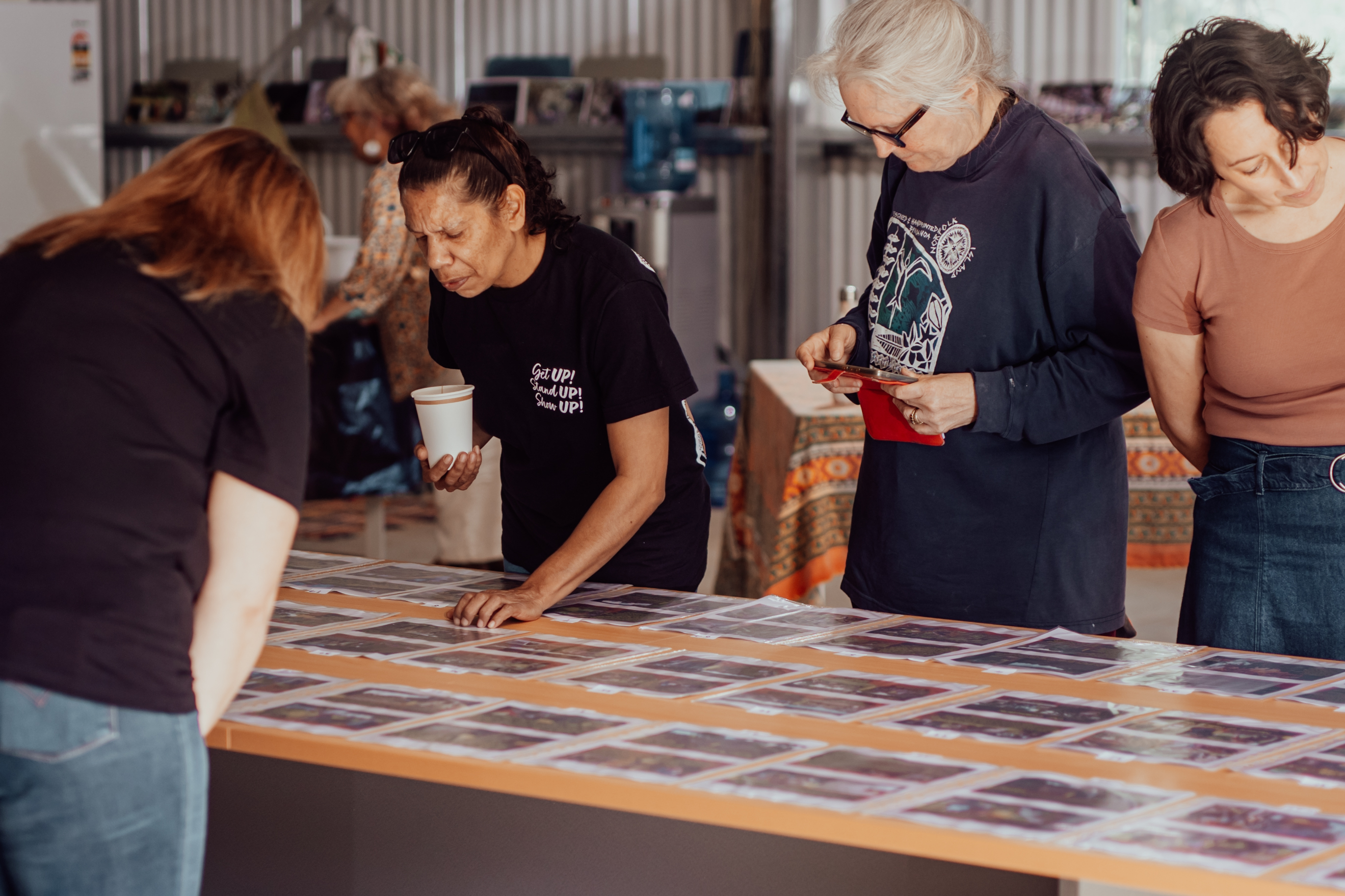 People standing around art table