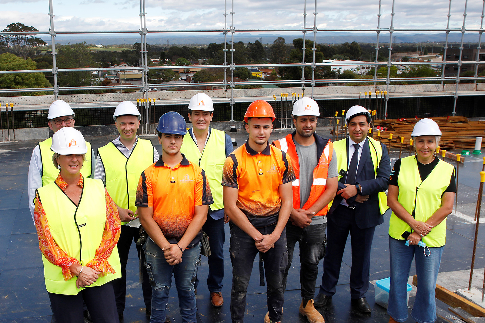 Ministers, builders and tradespeople with Jody Broun, AHO CEO, at the announcement